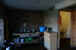 The shower and toilet stall to the right is one of few rooms that has electricity.