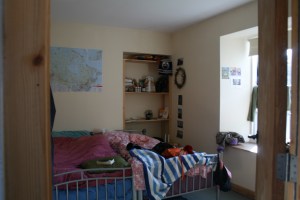Our bedroom.  Notice the map of Canada and Oilers towel as well as two postcards on the wall.